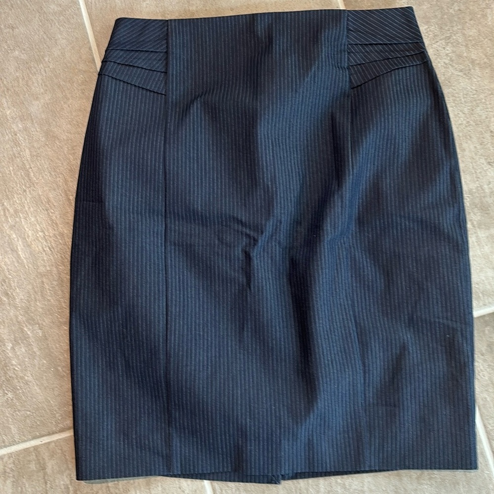 Woman’s navy blue skirt with subtle thin stripes. Never worn. Slit in back.